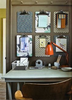 a desk with several pictures on the wall