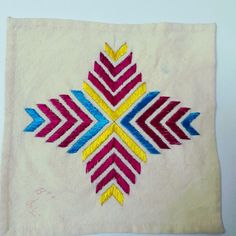 a white cloth with colorful designs on it