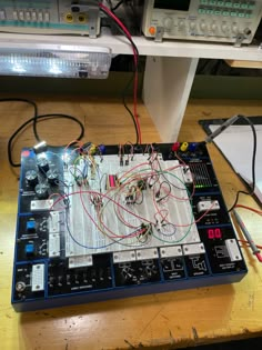 an electronic board with many wires attached to it