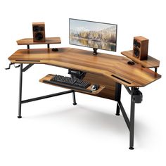 a computer desk with two speakers and a keyboard on it, sitting next to a monitor