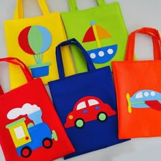 five bags with different designs on them sitting next to each other, one has a toy car and the other has a hot air balloon