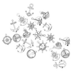 many different types of metal charms on a white background with an arrow and compass design