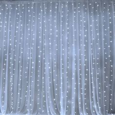 the curtains are covered with white lights