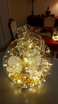 a glass bowl filled with lights on top of a table