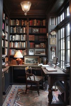 a home office with lots of bookshelves and a desk in the middle of it