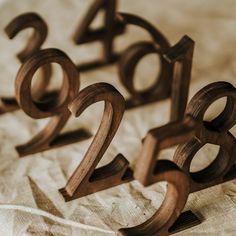 three wooden numbers sitting on top of a bed