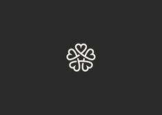 a white clover on a black background with the word love written in cursive writing