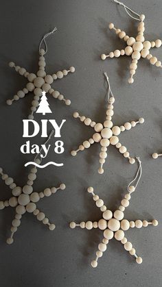 some white snowflakes are hanging on a gray surface with the words diy day 8