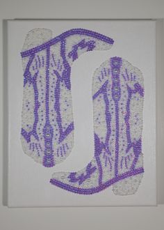 the letter u is made up of beads and sequins in purple on white