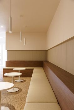 an empty waiting area with tables and chairs