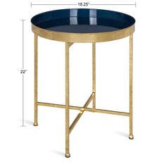 a blue glass and gold metal side table with an oval tray on the top,