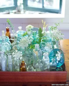 there are many glass bottles on the table