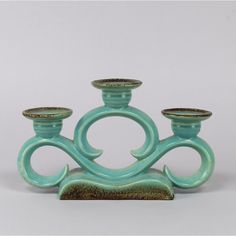 three candlesticks sitting on top of each other in front of a white background