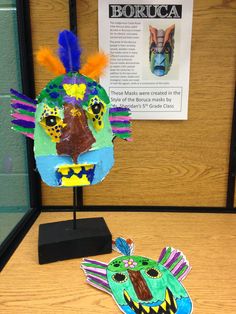 a paper mache is on display in front of a bulletin board