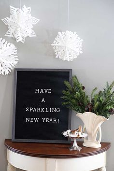 snowflakes are hanging from the ceiling above a sign that says have a sparkling new year