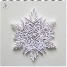 an intricate paper snowflake on a white background