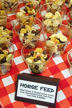 a table topped with cups filled with different types of cereal and corn on top of it