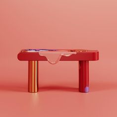 a red table with a toothbrush holder on it's top and a pink background