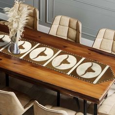 a wooden table with chairs and a vase on it