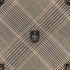 a brown and white checkered fabric with a crest on the center, surrounded by other plaid patterns