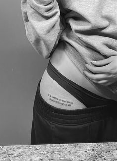 a woman's lower back with a quote on it