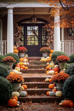 pumpkins and gourds are arranged on the front steps of a house in autumn