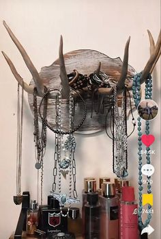 an antler's horns are hanging on the wall with chains and other items