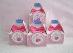 four pink boxes with pep the pig on them, one has a crown and two are decorated with polka dots