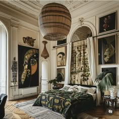 a bedroom with art on the walls and pictures hanging above it, along with a bed