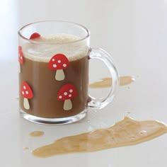 a glass mug filled with liquid and topped with mushrooms