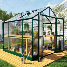 a green house sitting on top of a wooden deck