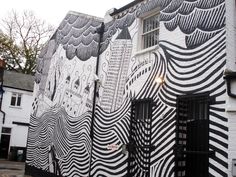 a black and white mural on the side of a building