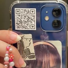 a person holding up a cell phone case with an image of a woman on it