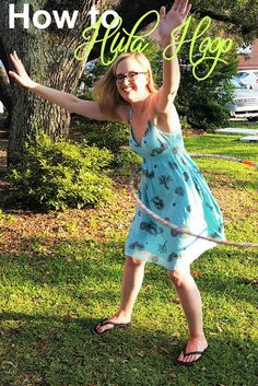 a woman standing in the grass with her arms up and hands out to catch a frisbee