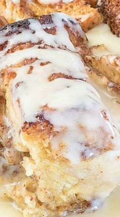 cinnamon roll with icing sitting on top of a white plate