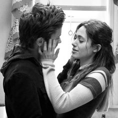 a man and woman standing in a kitchen next to each other