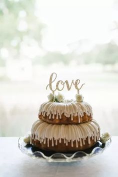 a wedding cake with the word love spelled on top