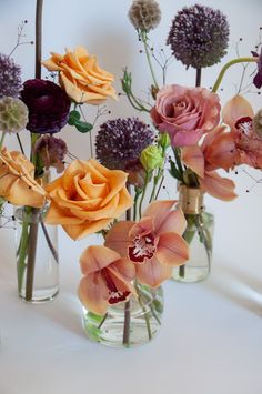 three vases filled with different types of flowers