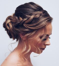 a woman with blonde hair is wearing a braid