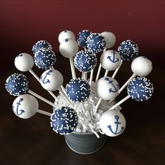 blue and white cake pops are arranged in a vase