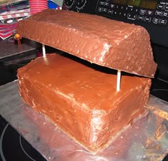 two square cakes sitting on top of each other in front of a computer monitor and keyboard