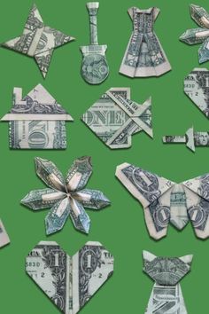 money origami pieces arranged in the shape of bow and arrow on green background