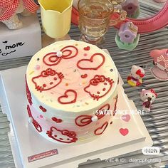 a hello kitty themed cake on a table