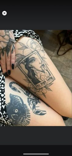 a woman's legs with tattoos on them