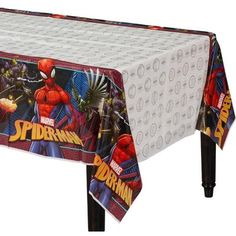 a spiderman themed tablecloth on top of a plastic table with an image of the character