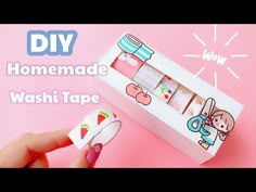 someone is holding up a washi tape dispenser in front of a pink background