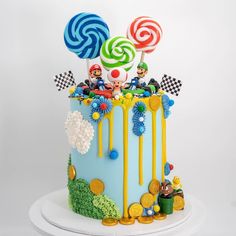 a birthday cake decorated with candy and lollipops