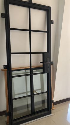 an open glass door in the corner of a room