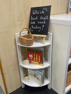 a bookshelf with a chalkboard sign on it next to some baskets and toys