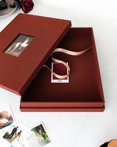 an open box with a ribbon on it and pictures in the bottom right hand corner